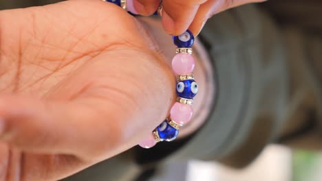 person wearing an evil eye bracelet
