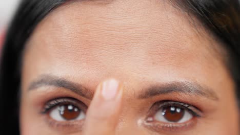 Close-up-of-woman-putting-bindi