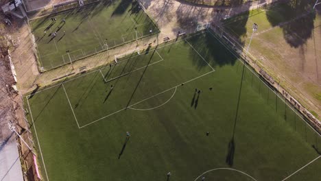 football players train to score goals on green soccer field in argentina