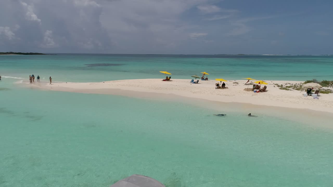 AERIAL FOOTAGE STUNNING BEACH WITH PEOPLE ENJOY TROPICAL GETAWAY, LOS ROQUES