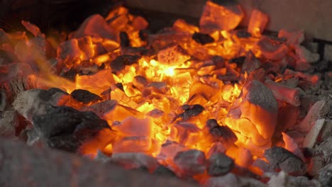 a fire and embers burning close up as they glow with heat