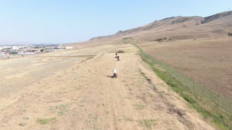 Aerial-Over-Atv-Scooters-And-Riders-Moving-Across-A-Landscape-In-The-Republic-Of-Georgia-1