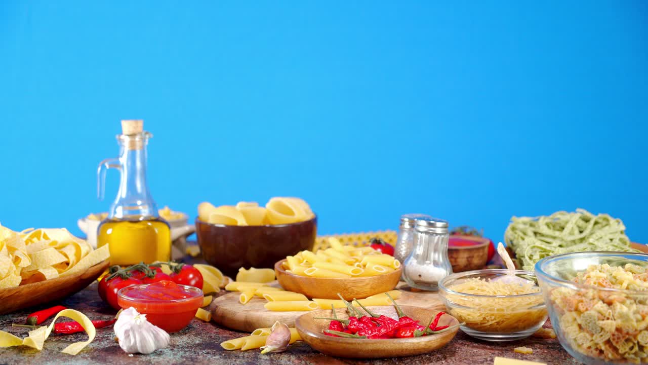 Different types of dry pasta on the table slowly rotating.