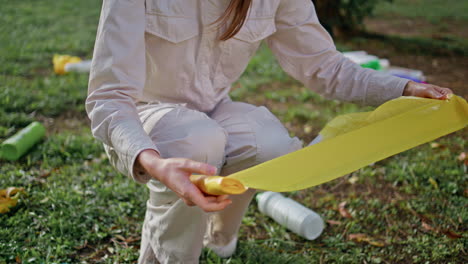 woman hand plastic bag at cleanup action in green park closeup. eco volunteer