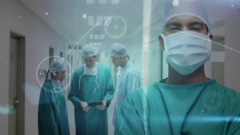 in hospital corridor, medical professionals in scrubs processing data with animation overlay