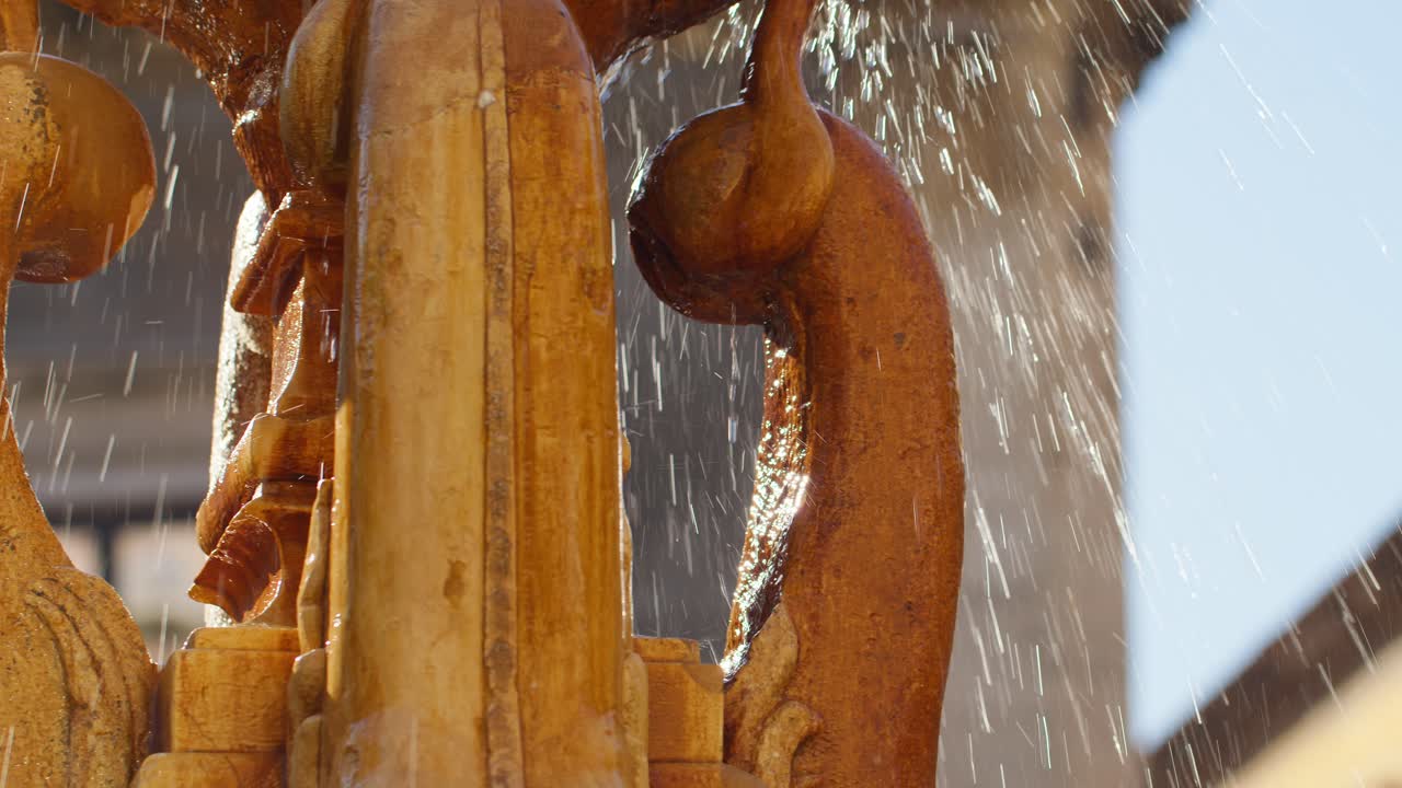 Close-up of water splashing in the golden water fountain at Piazza Vincenzo Bellini, Catania