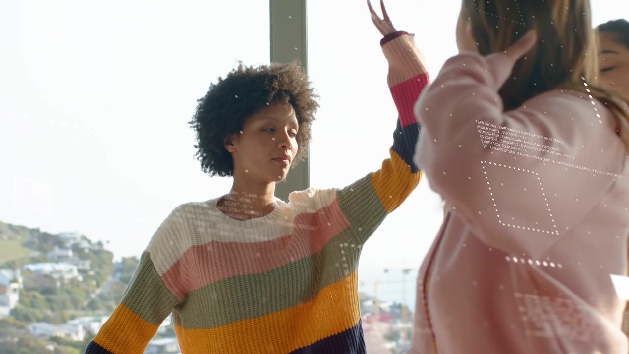 Stylist lifting brush, applying makeup to striped woman by window for styling, HUDs obscuring faces