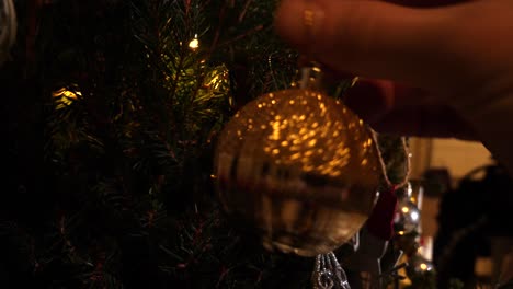 family decorating the christmas tree - close up of helping hands adults and child