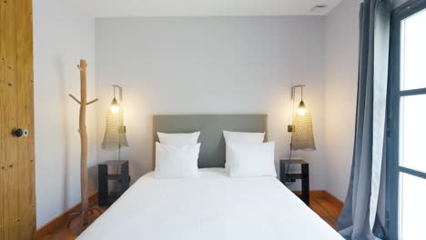 slow descending shot of a bedroom with symmetrical bedside cabinets