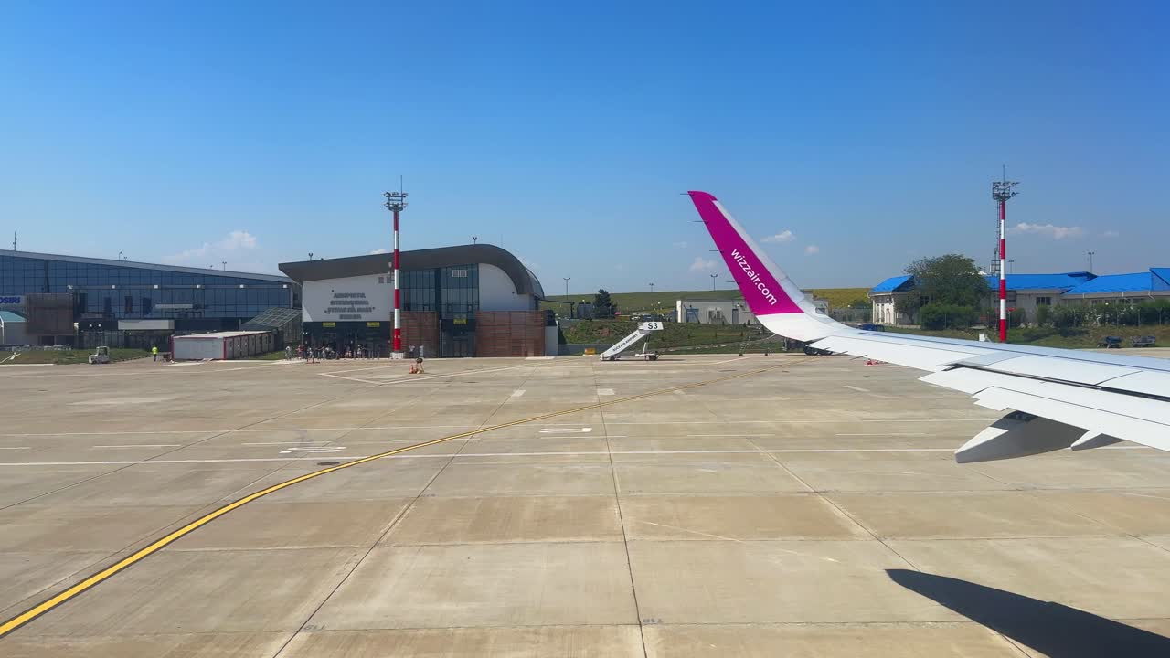 Plane window view takeoff Suceava Airport in Romania, fly airplane wing view