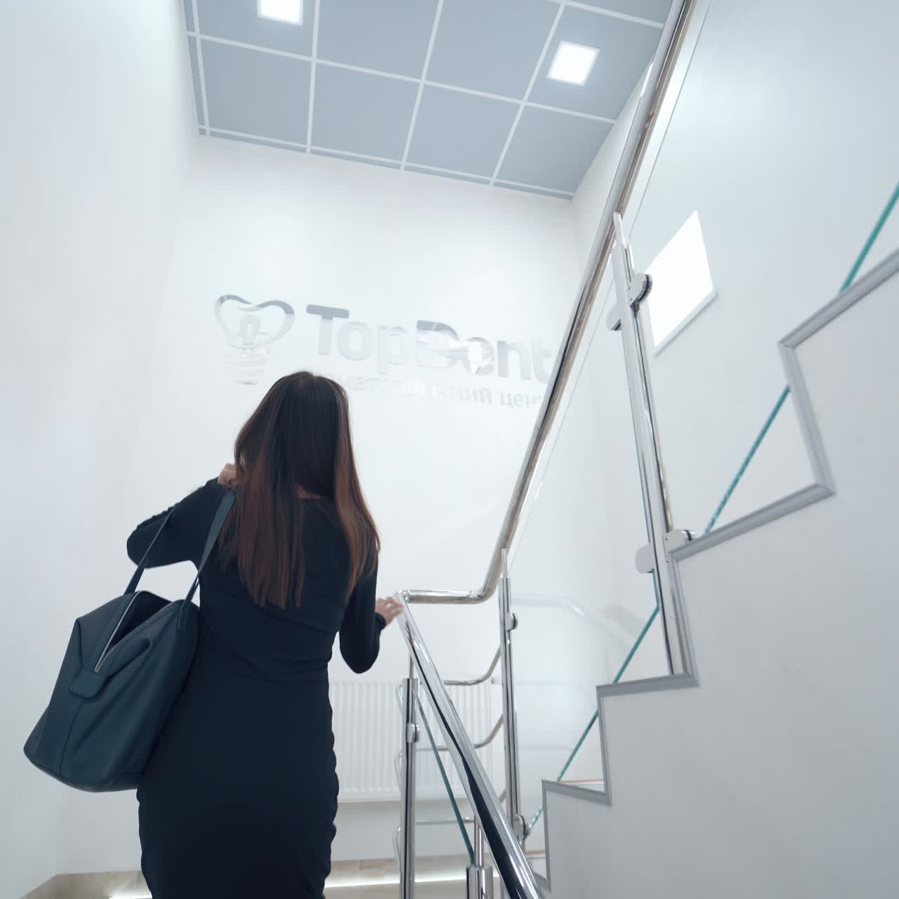 Woman indoors on the stairs