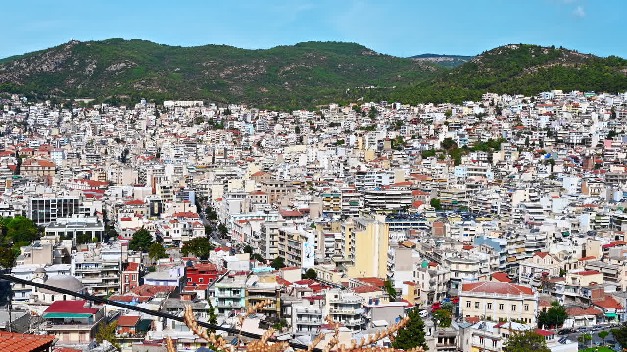 KAVALA, GREECE - SEPTEMBER 23, 2020: Aerial view of the city. Rows of residential buildings , viaduct, roads, green hills on the background