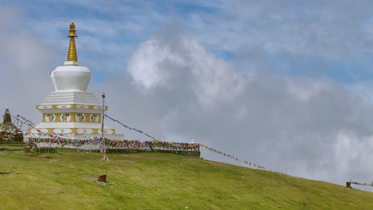 Nepal peaceful stupa and Buddhist praying place in Shailung Dolakha Drone shot with flags fluttering under a blue sky landscape green hills, forests, and mountain views, making it a tourism gem