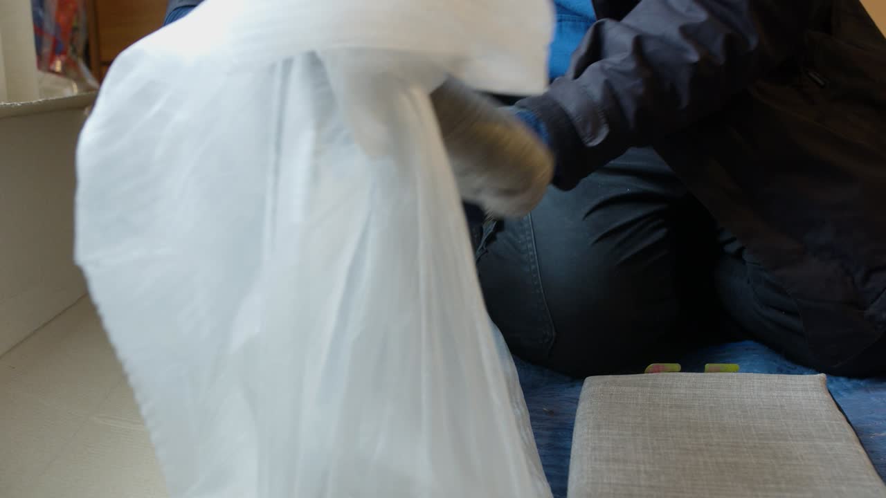 Unpacking and Assembling a New Grey Sofa