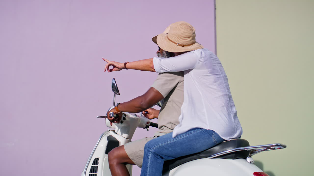 Couple riding a vintage scooter
