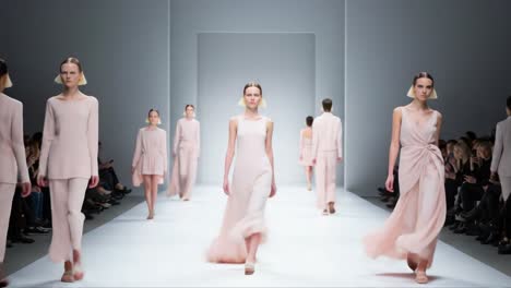 elegant fashion walk: a showcase of contemporary haute couture on the runway featuring stunning designs in soft pastels and minimalist silhouettes