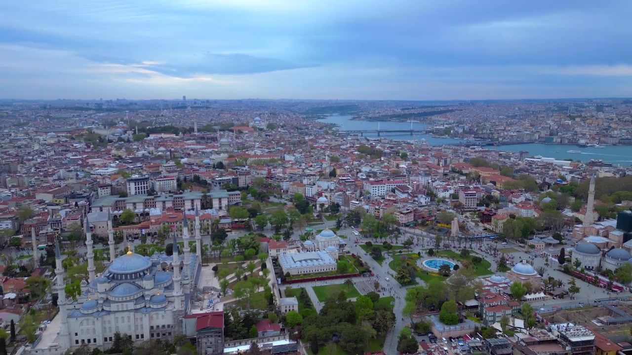 Sultanahmet Camii ve Ayasofya kubbeleri, minareleri, tarihi binaları ve Boğaz ile İstanbul şehir manzarası. Sola doğru dönen eşsiz bir havadan drone panorama görüntüsü.