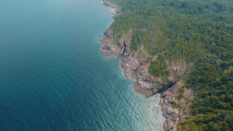 Aerial-Shot-Of-Tropical-Island-with-Crystal-Clear-Sea