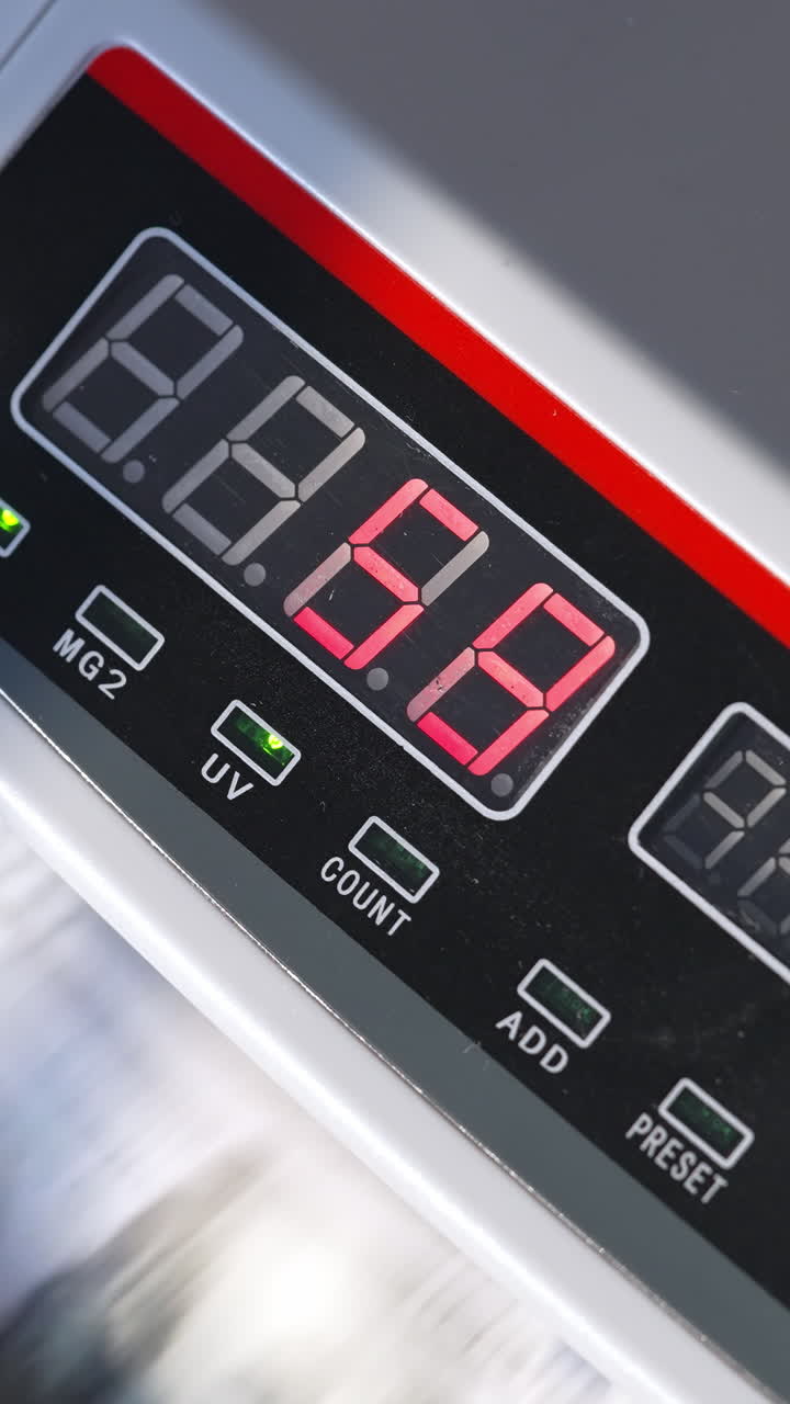Electronic cash counting equipment working. Unrecognized banknotes turning quickly in machine. Close up. Vertical video