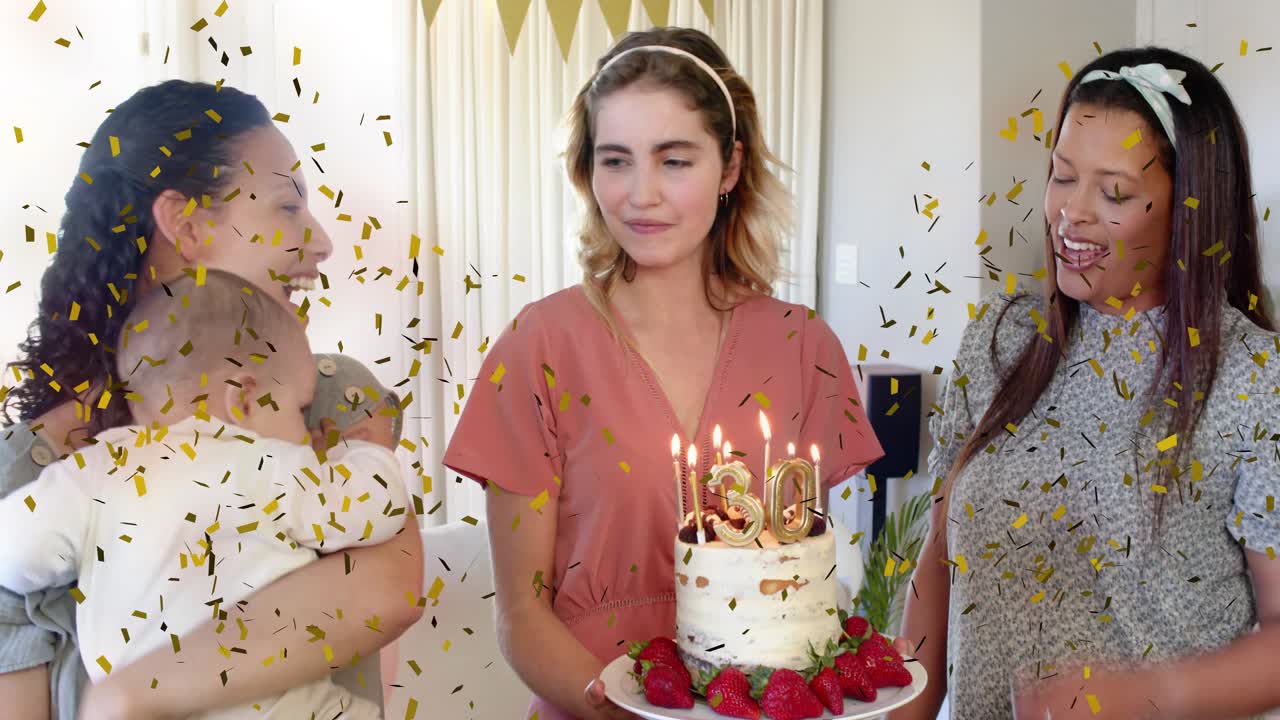 Center woman holding 30 cake leaning to blow candles, left pulling baby, confetti falling marketing