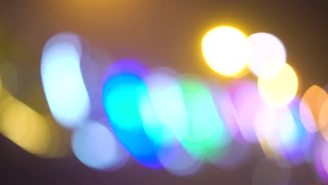 defocused lights of festive decorations on dark background