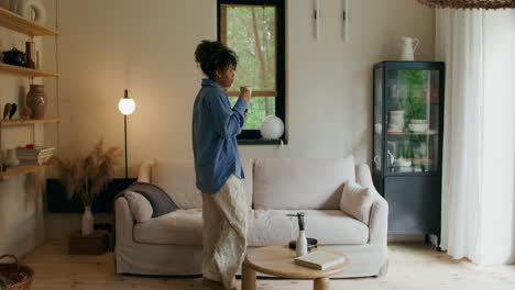 woman relaxing at home with coffee and tablet