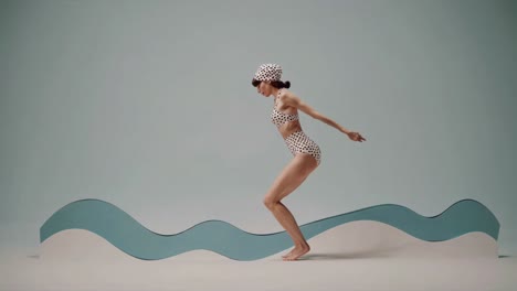 retro swimsuit model posing by waves