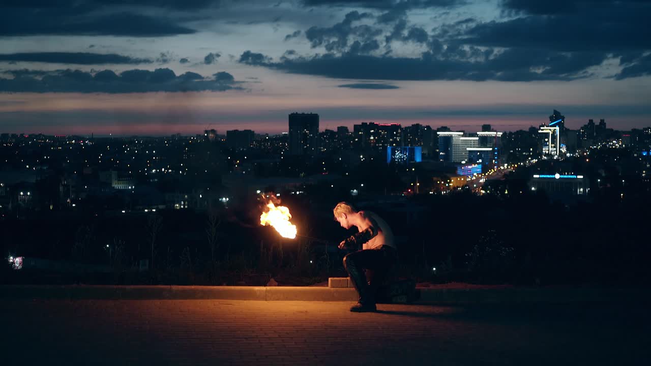 Young blond male getting ready to perform fire show male disappointed