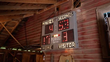 an old bulb light scoreboard in a vintage wooden barn