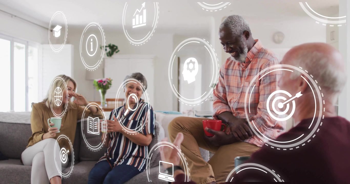 Senior man gesturing and summoning white digital IT icons while friends sitting on sofa interacting