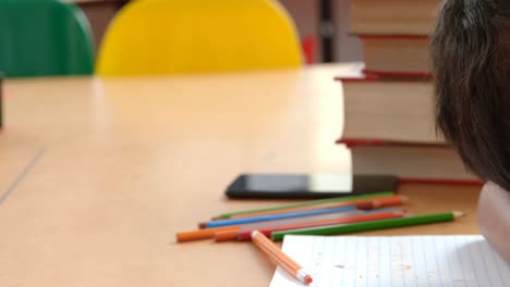 side view of asian schoolboy sleeping on desk in classroom at school 4k