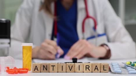 doctor's desk with antiviral medication and pills