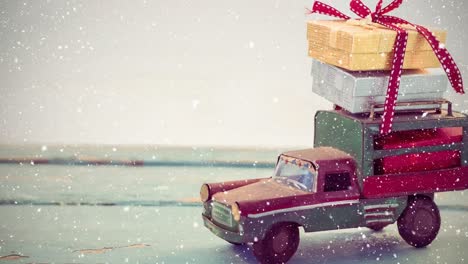 Model-car-with-christmas-presents-on-its-roof-combined-with-falling-snow