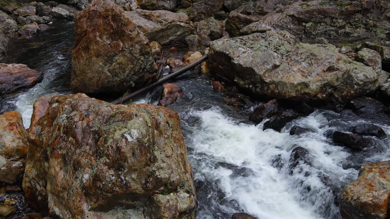 Water cascading over rocks and boulders in New Zealand mountain rocky river