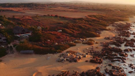 slow drone movement towards coast line and luxury rental villa ocean front in oaxaca mexico