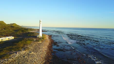 aerial view of a rocky beach and lighthouse in south africa