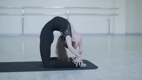 young ballet girl at studio lesson. training performance. stretching exercise pose. ballerina practice balance technique. classical elegance fitness.