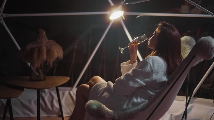 Depressed woman drinks alcohol in attempt to find solace and calmness while being alone. Sad moment in life and mental health problems slow motion