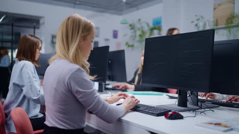 Women coding in an office