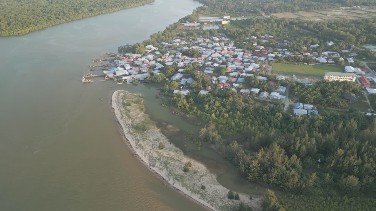 Aerial Drone View During Summer Gerigat Fishing Village,Kabong With, Facing Open Blue Sea, White Sandy Beach,Green Coconut, Palm Trees,And River,Sarawak,Borneo