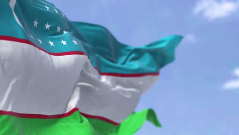 detail of the national flag of uzbekistan waving in the wind on a clear day