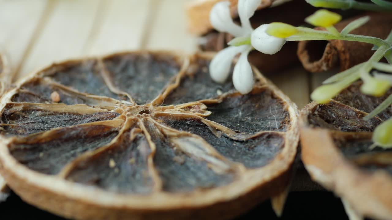 rebanadas de naranja secas, palitos de canela y flores