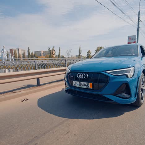 audi fully electric suv in cityy. full electric luxury crossover audi driving in bridge
