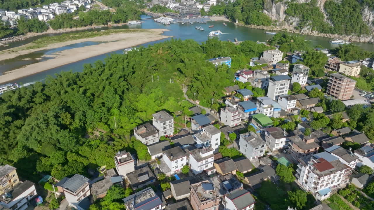 Aerial view tilting over the Ancient Town, toward modern Xingping, summer in China