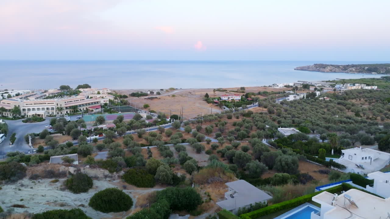 Aerial view over toward resorts of coastline of Rhodes, evening in Greece