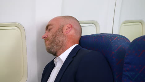 Close-up-of-man-asleep-on-an-airplane