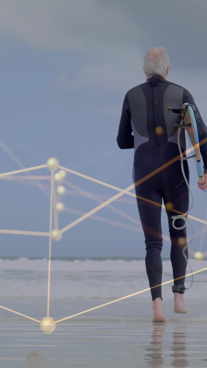 Vertical video: Senior surfer walking to ocean for sports, carrying board, overlay tracking motion