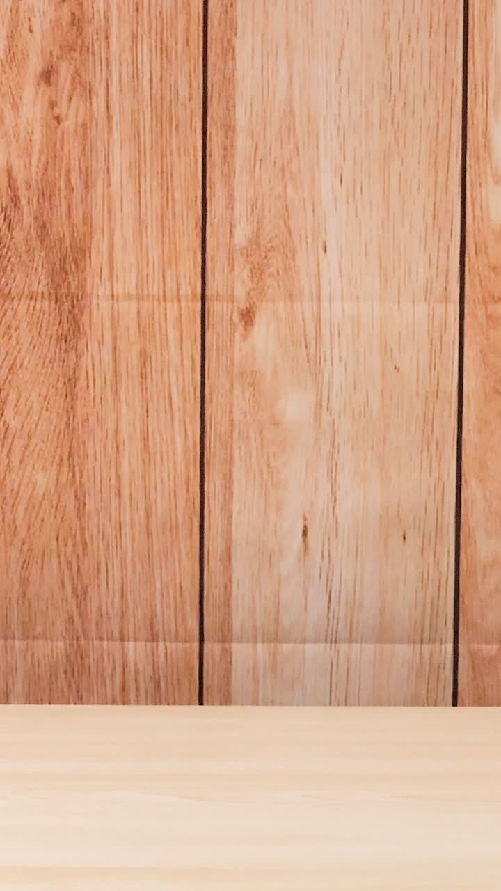 A tennis ball bounces against a wooden wall