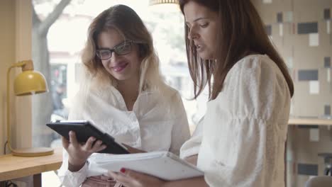 focused coworkers watching presentation on tablet