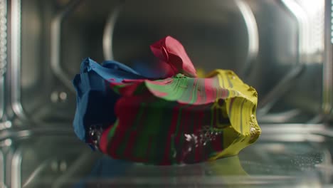 a vibrant explosion of color transformations inside a microwave: witness the unfolding of dynamic patterns and textures with melting pigments